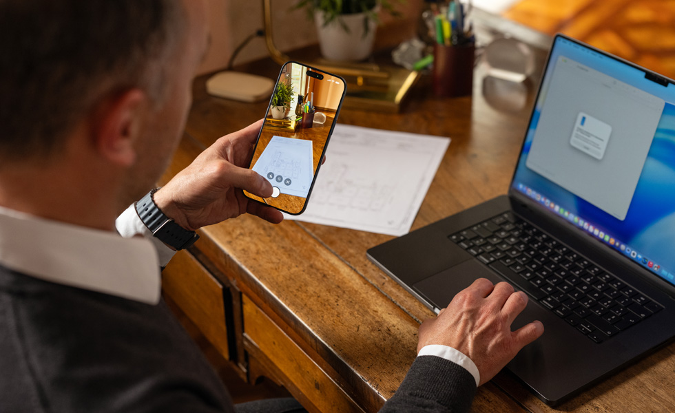 With Continuity Camera, Eugenio uses his iPhone to scan documents which then instantly appear on his Mac.