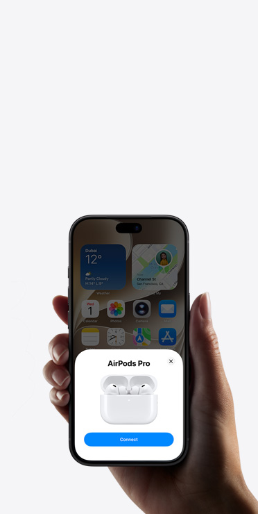 A hand holding an iPhone showing the Home app with a smart home accessory setup prompt