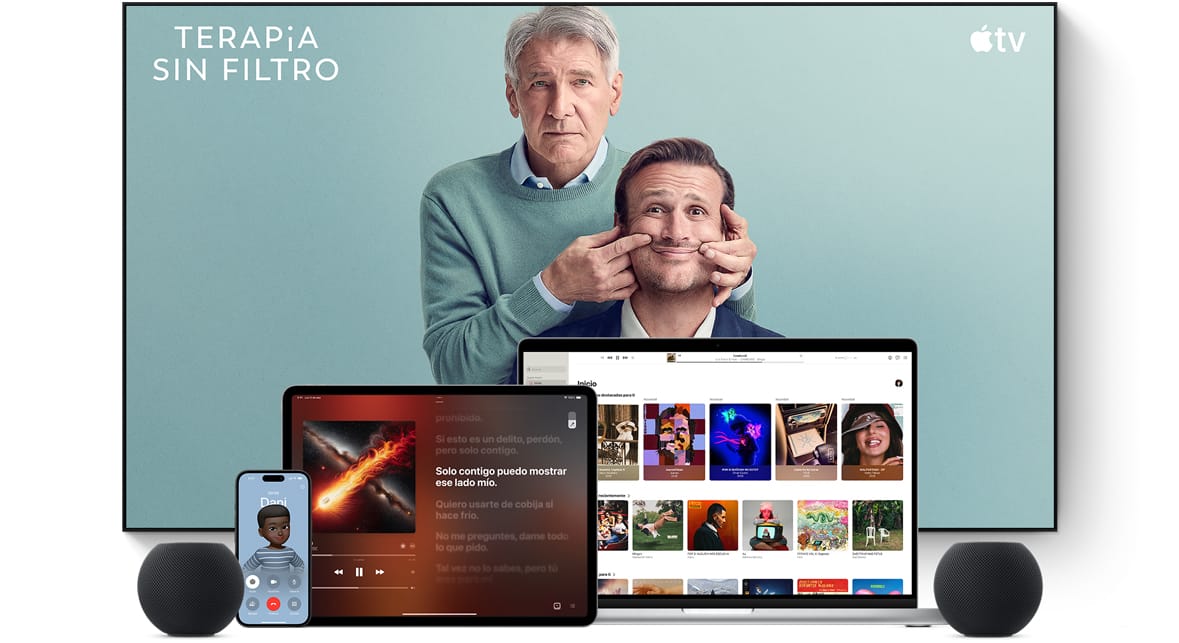 Una televisión grande de pantalla plana muestra a dos personajes masculinos de la serie Terapia sin filtro de Apple TV. Una MacBook Pro, un iPad, un iPhone y un HomePod mini color medianoche en primer plano.