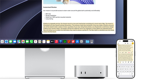 Mac mini front, tucked under Studio Display, an iPhone sits to the right of the device and the display, text selected with cut, copy, paste, and AutoFill commands above on iPhone matches highlighted text on display, showcasing Universal Clipboard