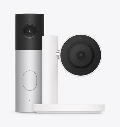 Apple Home Collection smart home camera, black lens and surround mounted on a white stand and arm