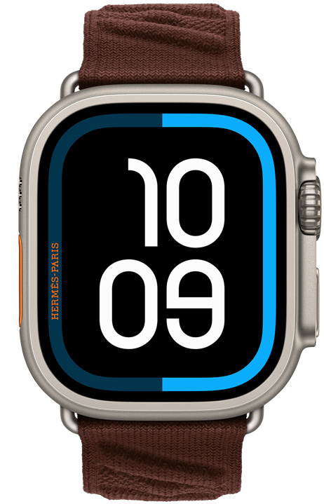 Apple Watch Hermès Ultra 4, quadrante digitale Maritime, cassa in titanio naturale, lato destro, Digital Crown, tasto laterale in rilievo, cinturino En Mer color Bordeaux (marrone scuro) in tessuto a maglia