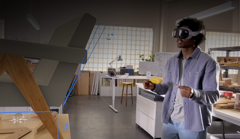 Apple Vision Pro를 착용한 디자이너가 손동작으로 의자의 3D 프로젝션을 측정하는 모습