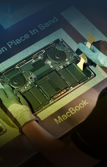 Gloved hands disassembling a MacBook, interior components visible