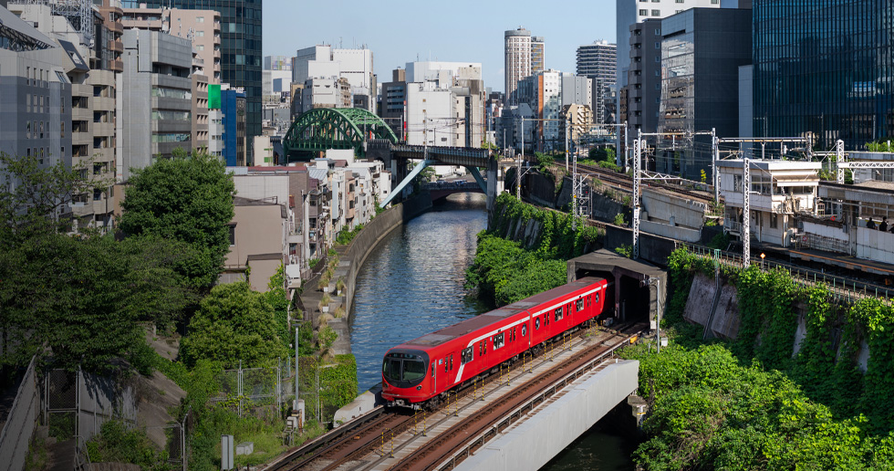 Glimpses of Tokyo Metro, including trains crossing bridges, daily operations, and maintenance work.